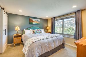 a bedroom with a large bed and a window at Cozy Estes Park Condo with Balcony and Fireplace! in Estes Park