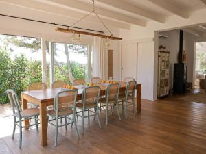 a dining room with a wooden table and chairs at Formentera Mind Yoga & Fit in Playa Migjorn