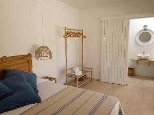 a bedroom with a bed and a mirror and a sink at Formentera Mind Yoga & Fit in Playa Migjorn
