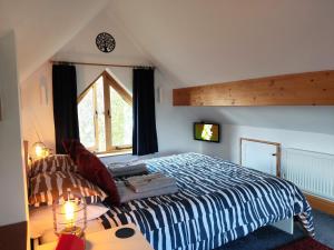 a bedroom with a king sized bed and a window at The Studio, Upper House Farm, Crickhowell with Double Garage and Free Parking in Crickhowell