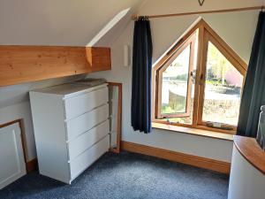 a small bedroom with a window and a dresser at The Studio, Upper House Farm, Crickhowell with Double Garage and Free Parking in Crickhowell +47 photos