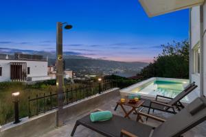 a patio with a pool and a table and chairs at SeaviewHeaven - Private pool - Overlooking Chania in Chania Town