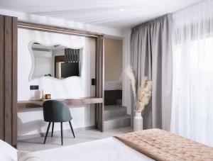 a bedroom with a bed and a mirror and a desk at Alcyone Studios and Apartments in Heraklio