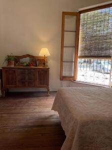 a bedroom with a bed and a window and a dresser at La casa de Agus in Gualeguaychú +12 photos