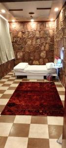 a bathroom with a bath tub and a red rug at Red Mountain Farm in AlUla