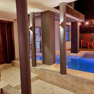 a swimming pool with columns in a building at Villa Doña Juana in Cancino Adentro