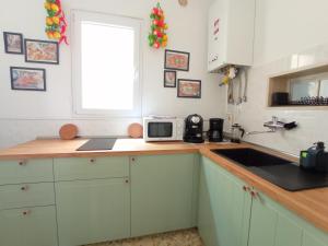 a kitchen with a counter with a microwave and a sink at ZEUS in Monopoli +16 photos