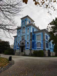 a blue building with a tower on a street at Su3ño Cántabro apto en Unquera in Unquera +40 photos