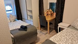 a small room with a desk and a chair and a table at XL Large & Cozy 2 bedroom Apartment nearly Hallstatt & Bad Ischl in Bad Goisern