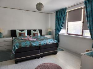 Un dormitorio con una cama con un juguete rosa. en Ferienhaus Ani & Apartment Rustikal, en Patzig