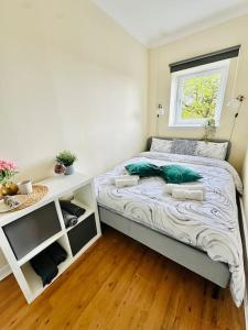 een kleine slaapkamer met een bed en een raam bij Dumbarton cosy home, Loch Lomond in Dumbarton