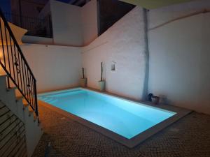 a large swimming pool in a room with a staircase at Santa Cruz - B&B in Lagos
