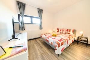 a bedroom with a bed and a flat screen tv at Central Old Town Oasis - Ap 10 in Bucharest