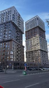 two tall buildings on the side of a street at Apartments in Grani in Dnipro