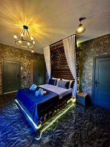 a bedroom with a large bed with a blue comforter at Qafqaz Modern Bungalow in Gabala