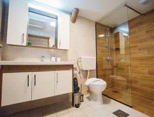 a bathroom with a toilet and a glass shower at Urban Studio Apartments in Strumica