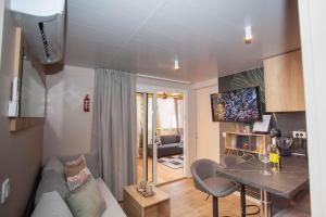 a living room with a couch and a table at Mobile Home Ivana in Biograd na Moru