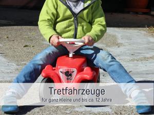 a man is sitting on a toy toy car at Biohof Burger, 3 sonnige Fewo, alle mit Balkon, Spielzimmer, Grillhütte, 7 km vor Oberstdorf in Bolsterlang