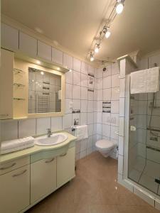 a bathroom with a sink and a toilet at Apartamenty Pod Dzwonkiem in Wadowice