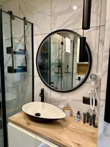 a bathroom with a sink and a mirror on a counter at Blisko Gór Szyndzielnia in Bielsko-Biała