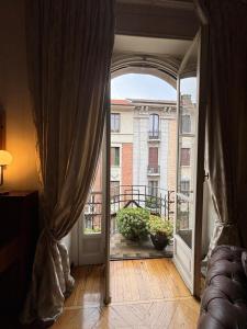 an open door to a balcony with a view of a building at Eleganza Liberty a due passi da Porta Susa e Metró in Turin