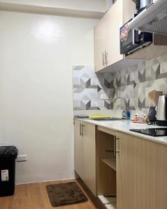 a kitchen with a sink and a counter top at Seawind Condo - Sea View Samal Island View Gene Vacation Homes in Davao City