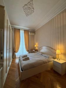 a bedroom with a large bed and a window at Eleganza Liberty a due passi da Porta Susa e Metró in Turin