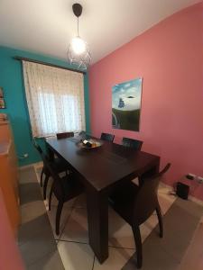 a dining room with a wooden table and chairs at K & R apartment 