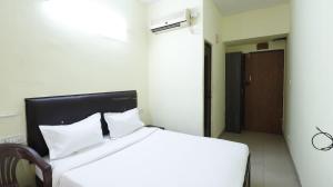 a bedroom with a large white bed with white pillows at ROYAL PARK NEAR BELLANDHUR,HSR in Bangalore