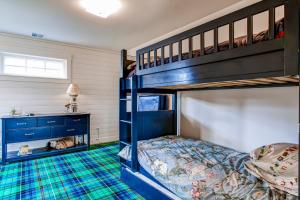 a bedroom with two bunk beds and a desk at Modern Gearhart Getaway, Walk to Beach and Downtown! in Gearhart