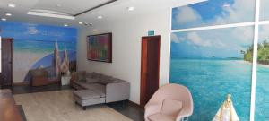 a living room with a mural of a beach at Hotel Yaque Club in Porlamar