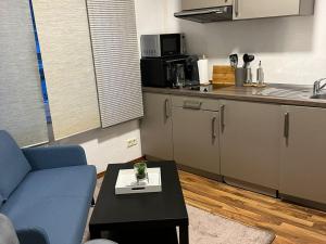 a living room with a couch and a table and a kitchen at Stadtnahen Wohnung I Küche I Oelde in Oelde +14 photos
