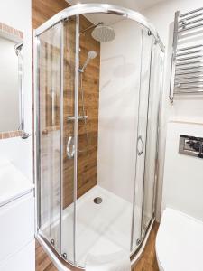 a shower with a glass enclosure in a bathroom at Beskidian in Węgierska Górka