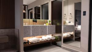 a bathroom with a sink and a mirror at Garden Park Hotel in San Miguel de Tucumán