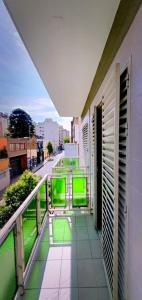 a balcony of a building with green screens on it at HOTEL RESIDENCIAL CAMACHO in Cordoba