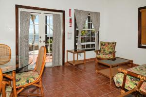 a living room with a glass table and chairs at X'tan Ha- The Waterfront in San Pedro