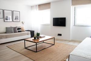 a living room with a couch and a coffee table at Earth Element Apartment in Peniche