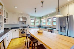 a large kitchen with a wooden table and chairs at Harbor Haven in Seattle