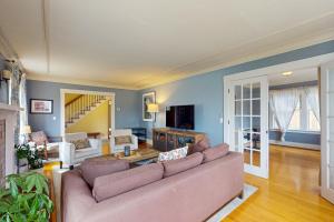 a living room with a couch and a tv at Harbor Haven in Seattle