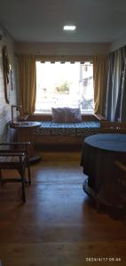 a room with a large window with a bed in it at BALCON CORDILLERANO in El Bolsón