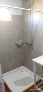 a shower with a glass door in a bathroom at BALCON CORDILLERANO in El Bolsón