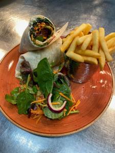 a plate of food with a sandwich and french fries at Dartmoor Halfway Inn in Newton Abbot