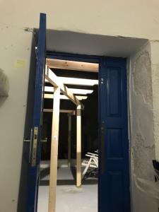 an open blue door in a room with a ceiling at Poudras Amazing View Caldera in Órmos Athiniós