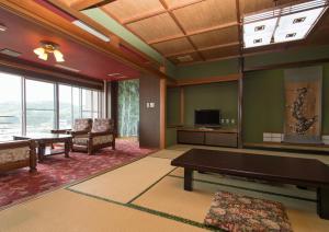 sala de estar con mesa de billar y TV en Izuito Onsen Daitokan, en Ito