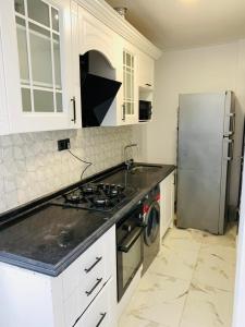 a kitchen with a stove and a refrigerator at Dakar Creek in Dakar