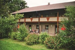 a house with a person standing in front of it at Gästehaus Leithen in Bad Birnbach