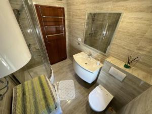 a bathroom with a sink and a toilet and a mirror at Royal Antique Apartment in Split +45 photos