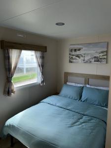 a bedroom with a bed and a window at The Lay By in Prestonpans