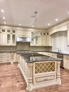 a kitchen with white cabinets and a large island at Vihome520-2 Queen Beds near North York center in Toronto