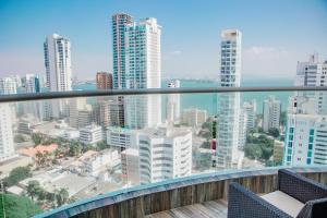 a balcony with a view of a city at Playa Cartagena Apartments in Cartagena de Indias